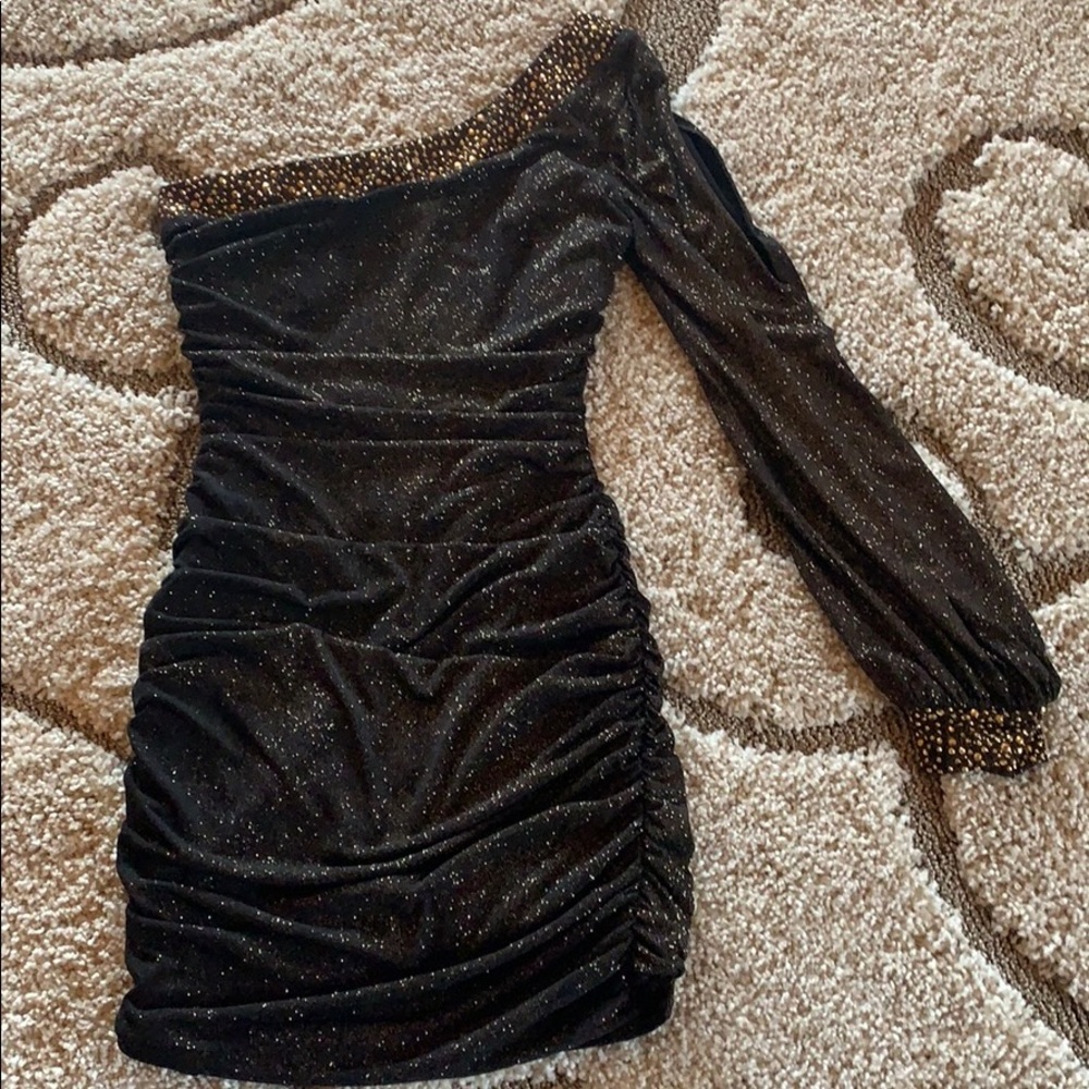 Sparkly gold one-shoulder dress.